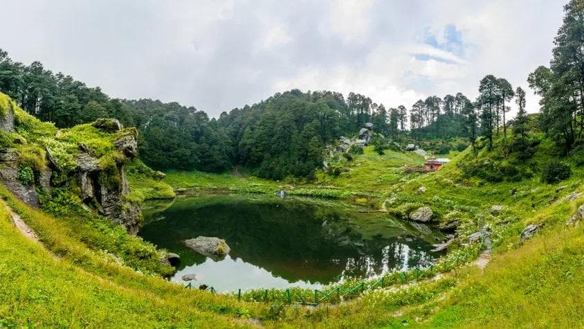 Serolsar Lake surrounded by dense pine and oak forest near Jalori Pass